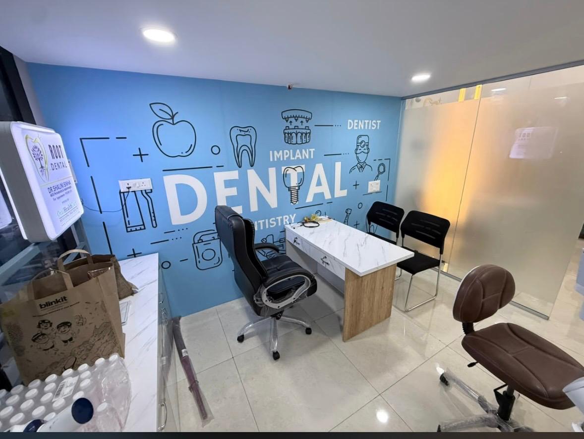 Treatment room with dental chair beneath a mural reading Implant, Dentist and Dental